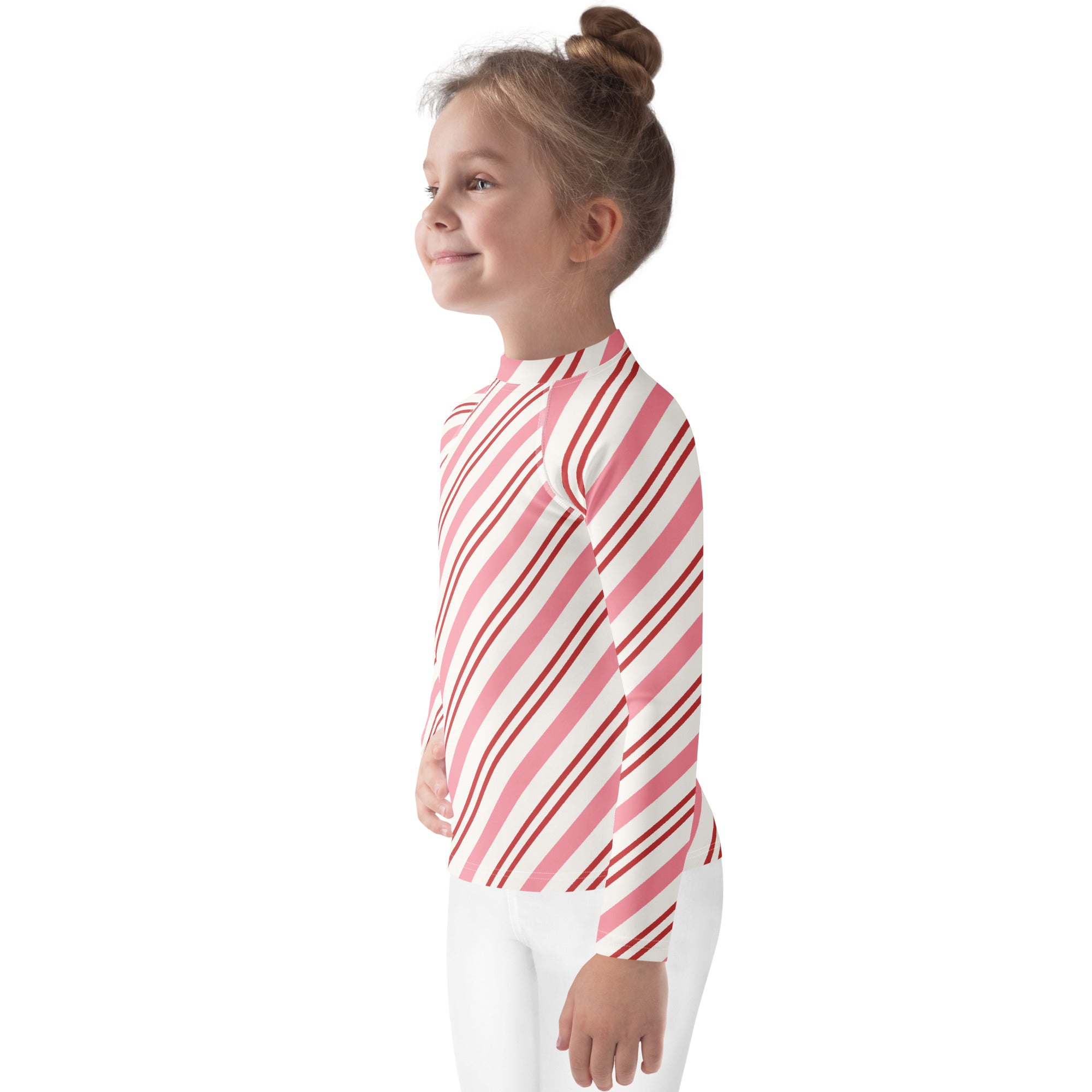 A child wearing a kids pink peppermint stripe long sleeve rash guard swim shirt with upf 50 plus for sun protection
