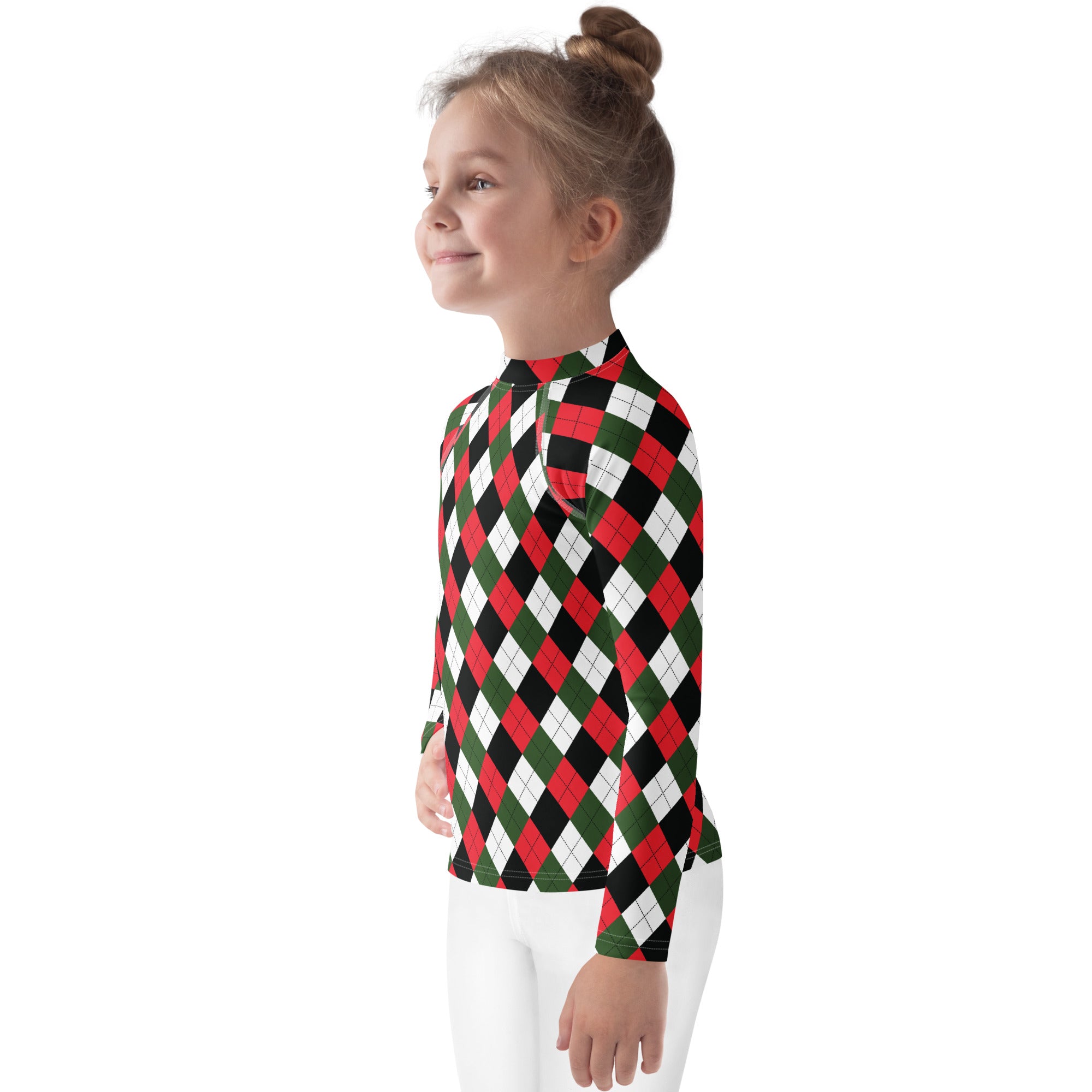A child wearing a kids christmas argyle long sleeve rash guard swim shirt with bold red green black and white pattern and UPF 50+