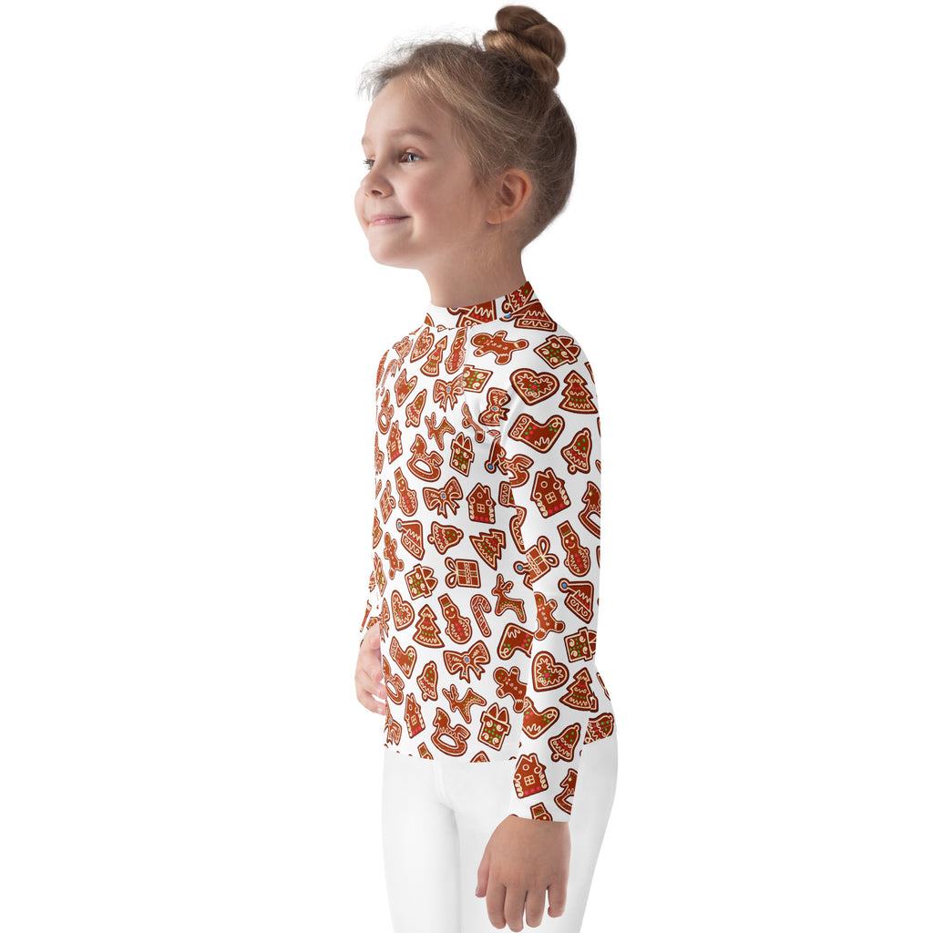 A child wearing a white kids gingerbread cookie long sleeve rash guard swim shirt with UPF 50 plus protection