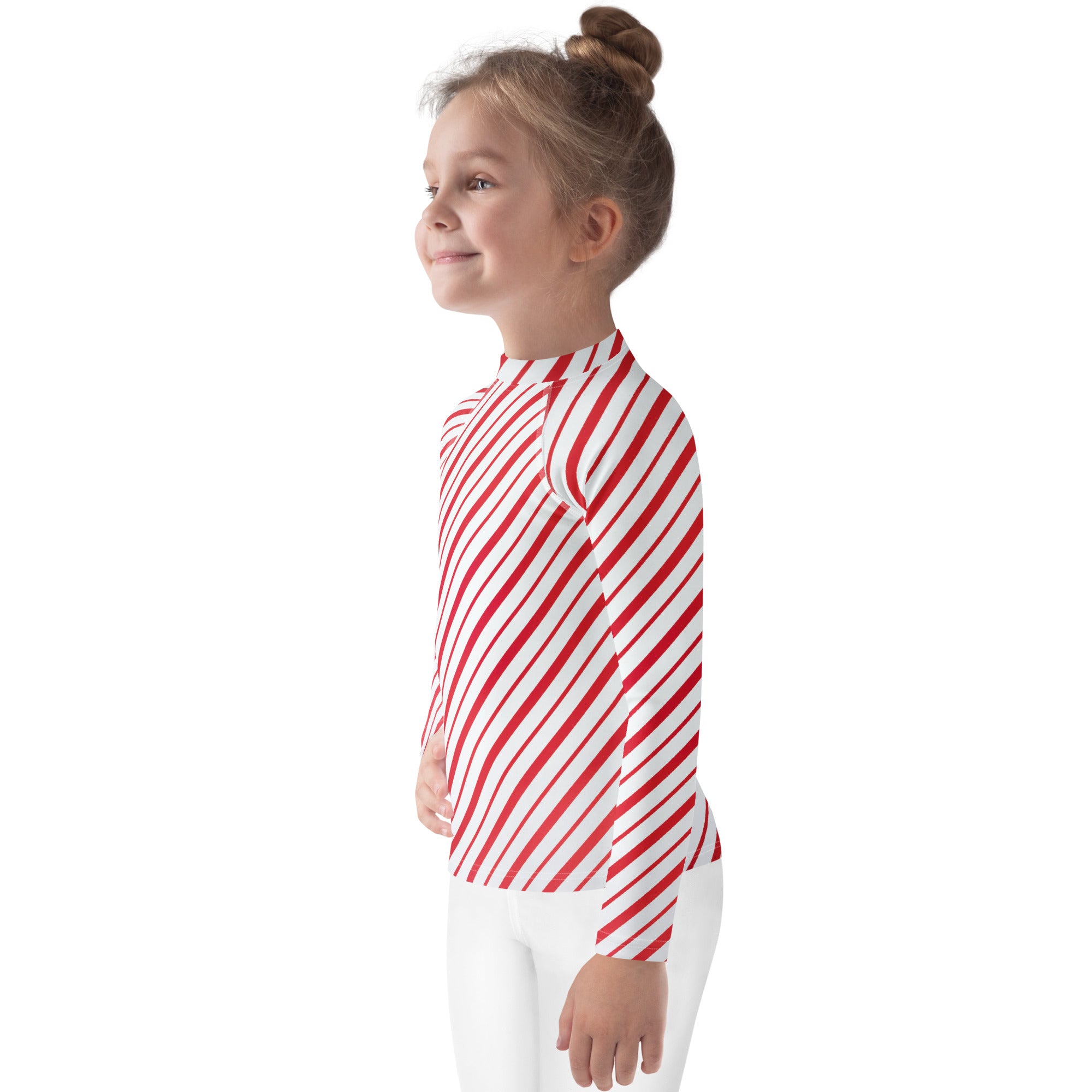 A child wearing a kids red and white candy cane striped long sleeve rash guard swim shirt with UPF 50 plus