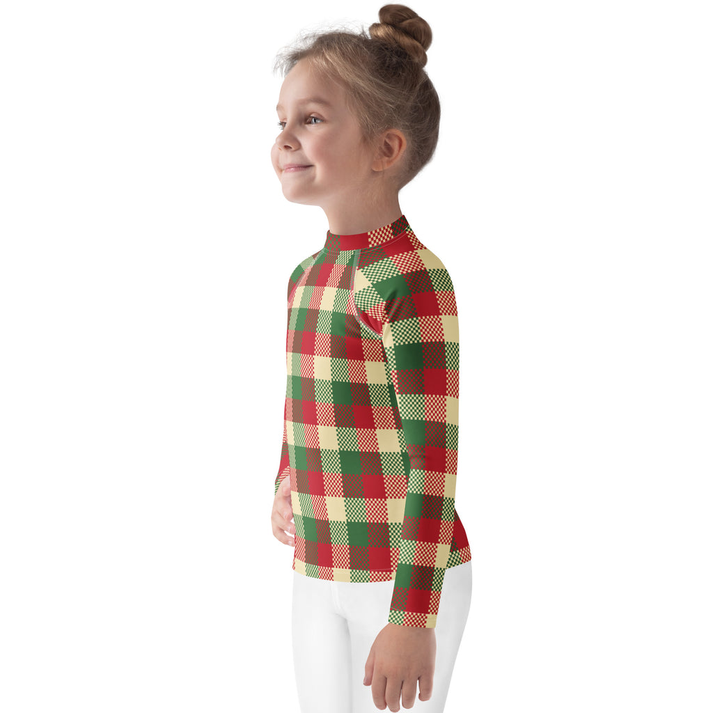 A child wearing a kids christmas plaid long sleeve rash guard swim shirt with UPF 50 plus in red green and cream colors