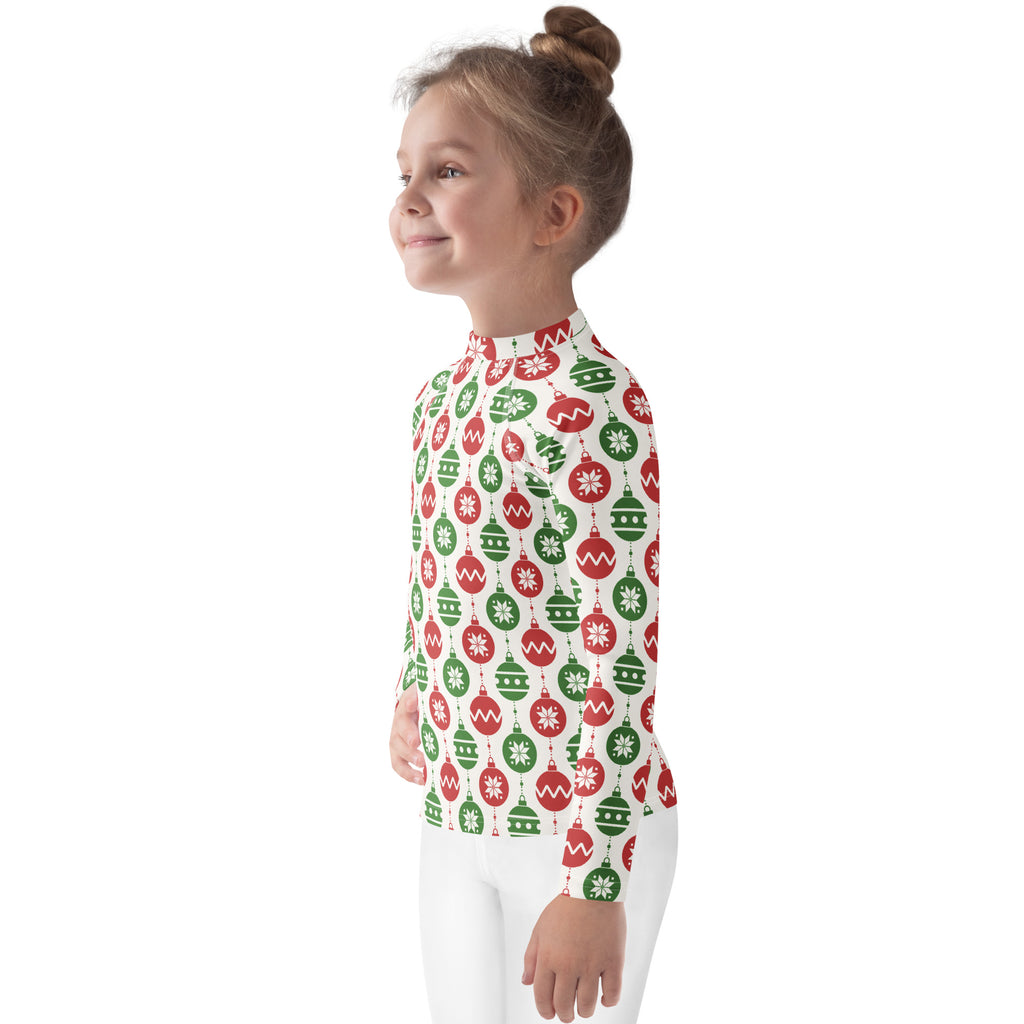A child wearing a kids red and green christmas ornament long sleeve rash guard swim shirt with upf 50 plus