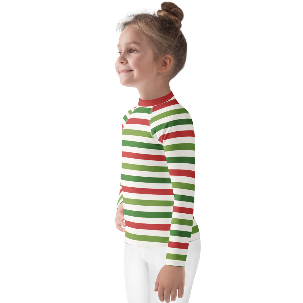 A child wearing a kids red and green christmas stripes long sleeve rash guard swim shirt with upf 50 plus