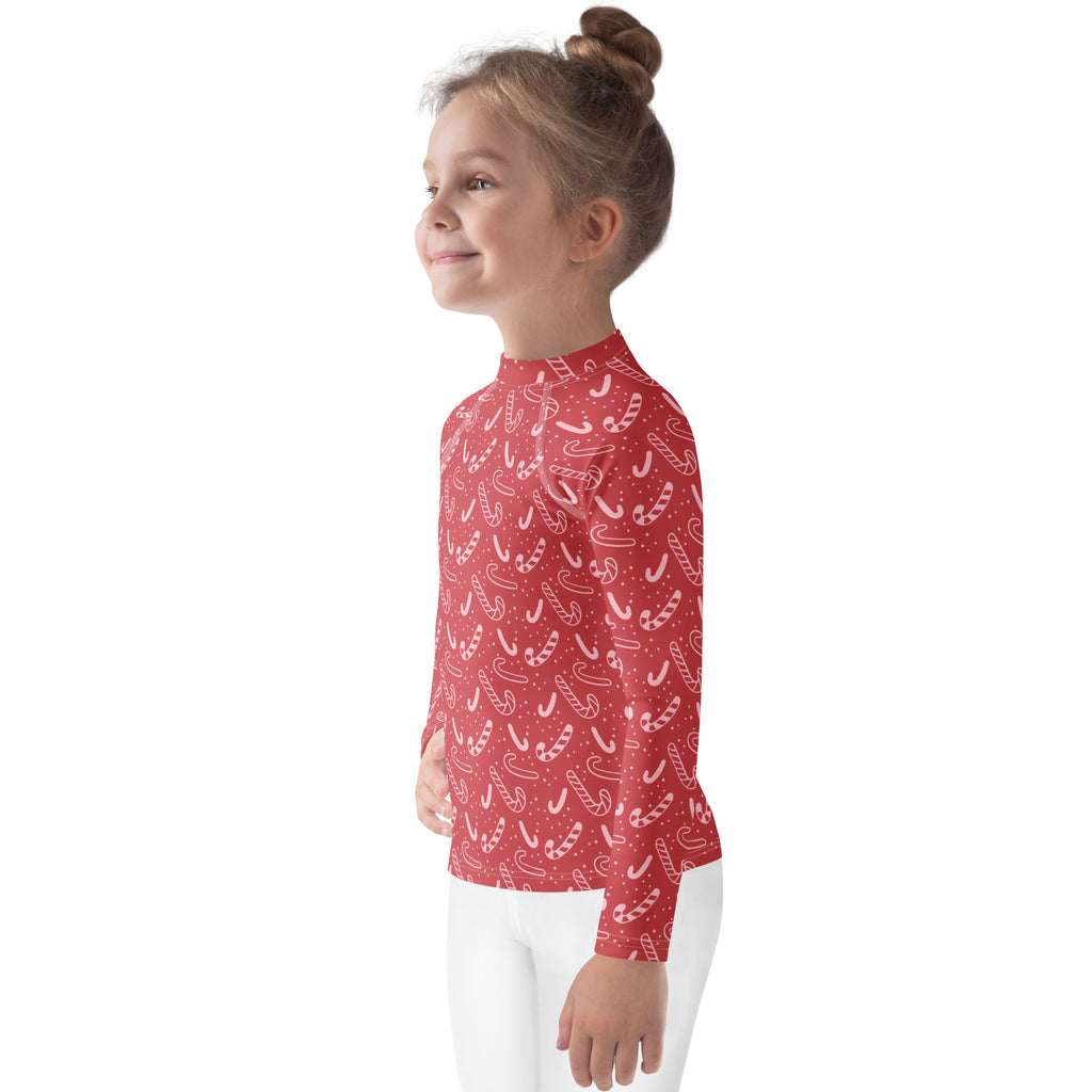 Kids red long sleeve rash guard swim shirt with white candy cane pattern and upf 50 plus sun protection