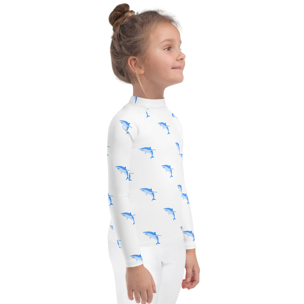 White kids long sleeve rash guard swim shirt with blue shark prints and UPF 50 plus sun protection
