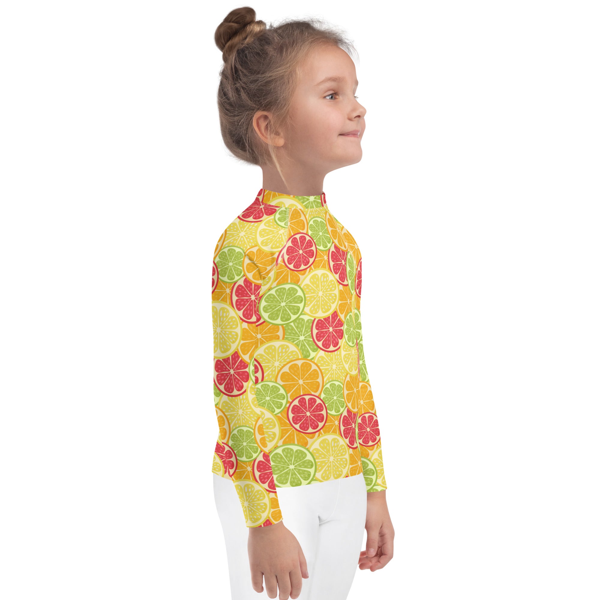 A vibrant yellow kids long sleeve rash guard swim shirt with citrus fruit pattern and UPF 50 plus sun protection