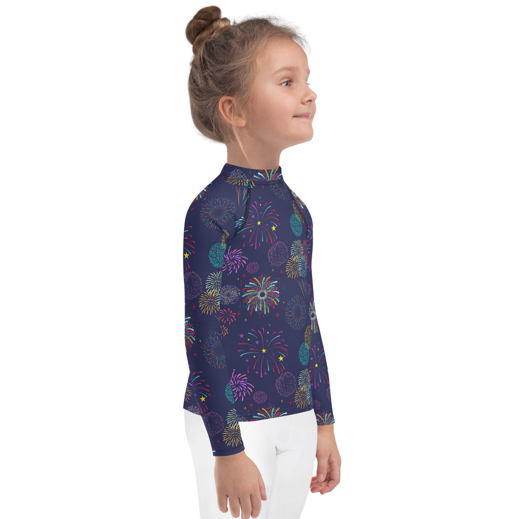 A navy blue kids long sleeve rash guard swim shirt with vibrant multicolored fireworks pattern and upf 50+ protection