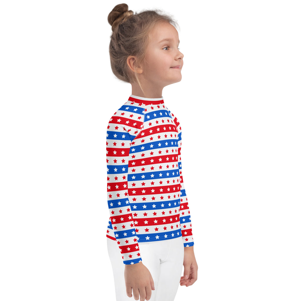 A child wearing a kids red white and blue stars and stripes usa long sleeve rash guard swim shirt with upf 50+