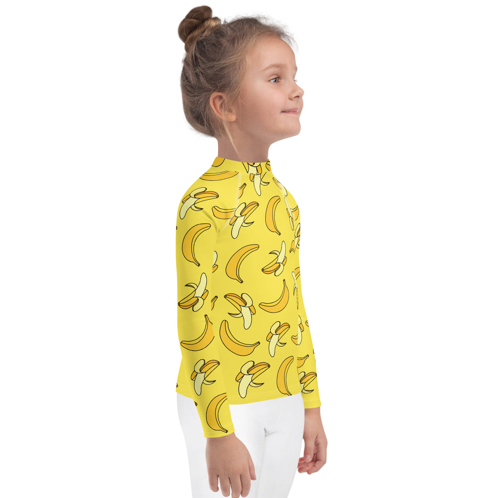 Yellow kids long sleeve rash guard swim shirt with playful banana pattern and UPF 50 plus sun protection