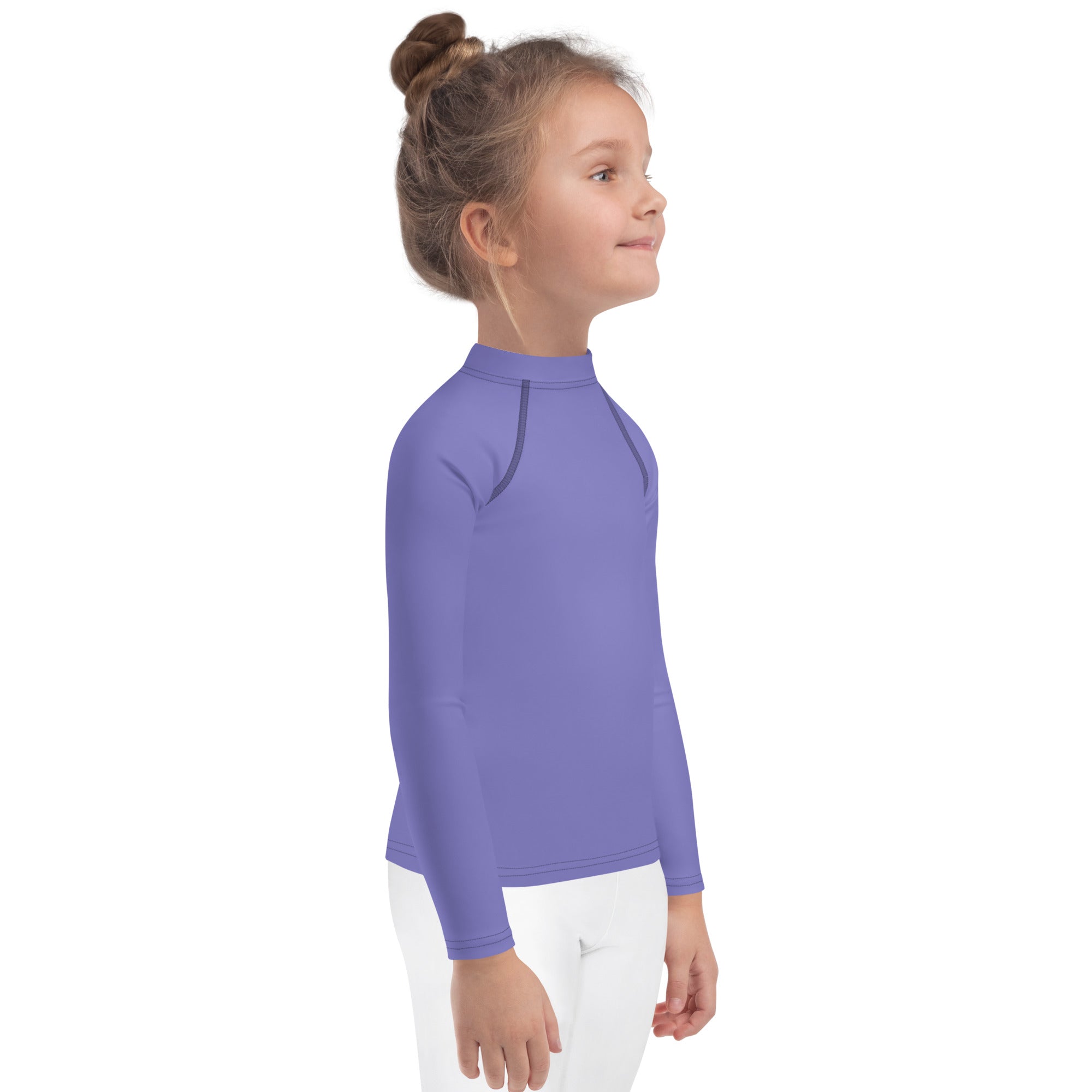 A child wearing a girls purple long sleeve rash guard swim shirt with upf 50 plus and subtle seam detailing