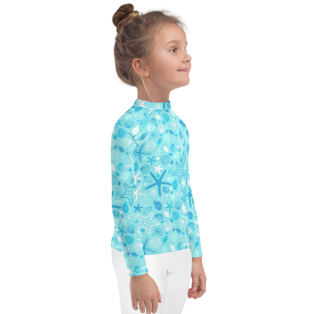 Turquoise kids long sleeve rash guard swim shirt with white and dark blue starfish and seashells pattern upf 50+