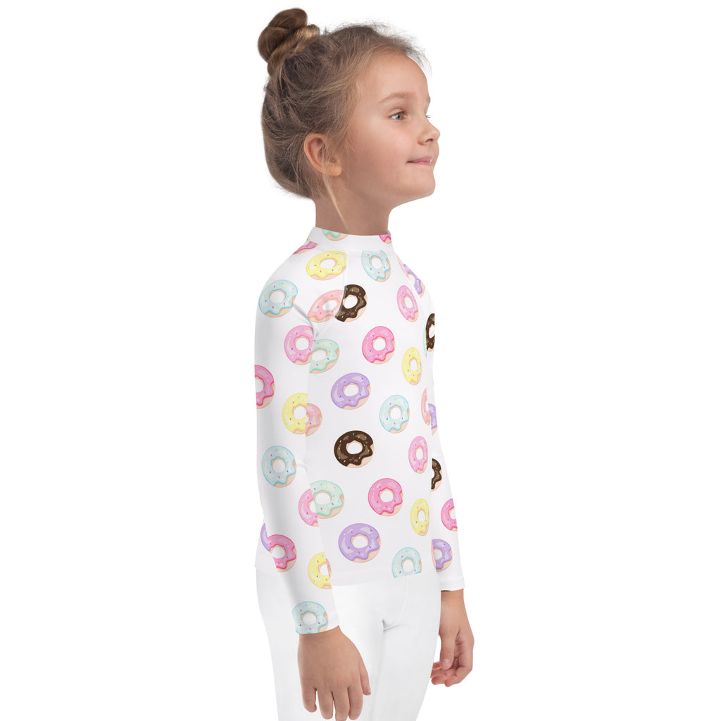 White kids long sleeve rash guard swim shirt with colorful pastel and chocolate donut pattern and UPF 50 plus protection