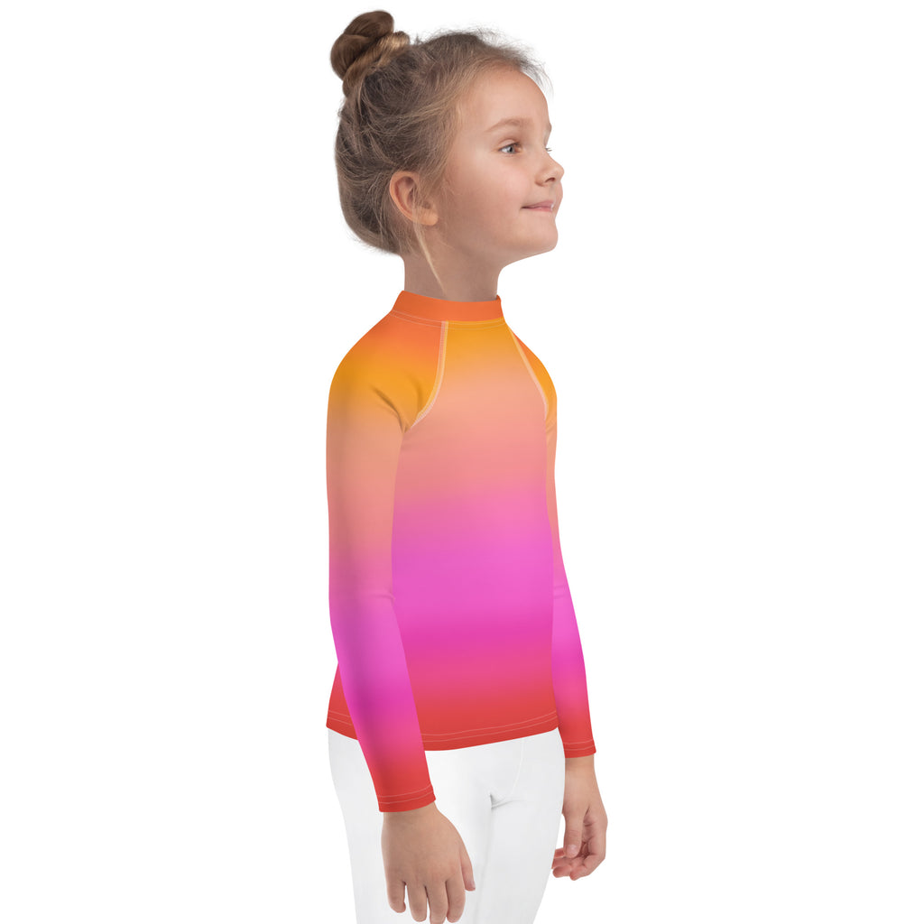 Girls sunset ombre long sleeve rash guard swim shirt in vibrant orange pink and red hues with UPF 50 plus protection