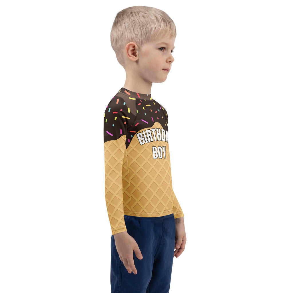 A child wearing a birthday boy chocolate ice cream cone long sleeve rash guard swim shirt with UPF 50+