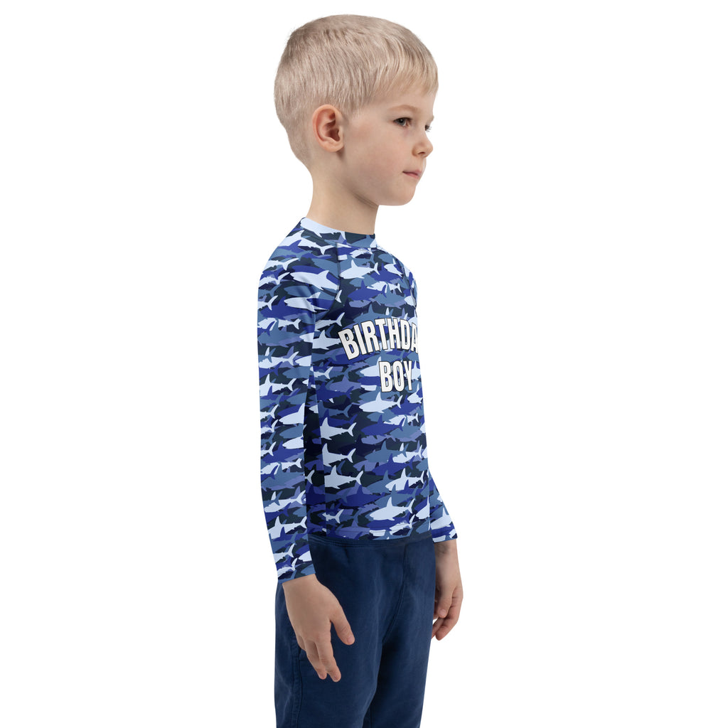 Blue long-sleeved rash guard with shark camouflage pattern and birthday boy text on chest for custom birthdays
