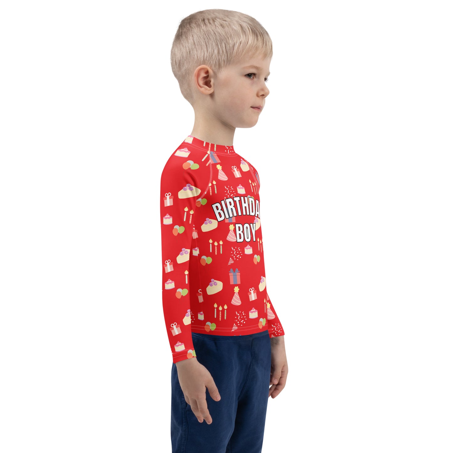 Child wearing a red 'Birthday Boy' shirt with birthday patterns on a white background