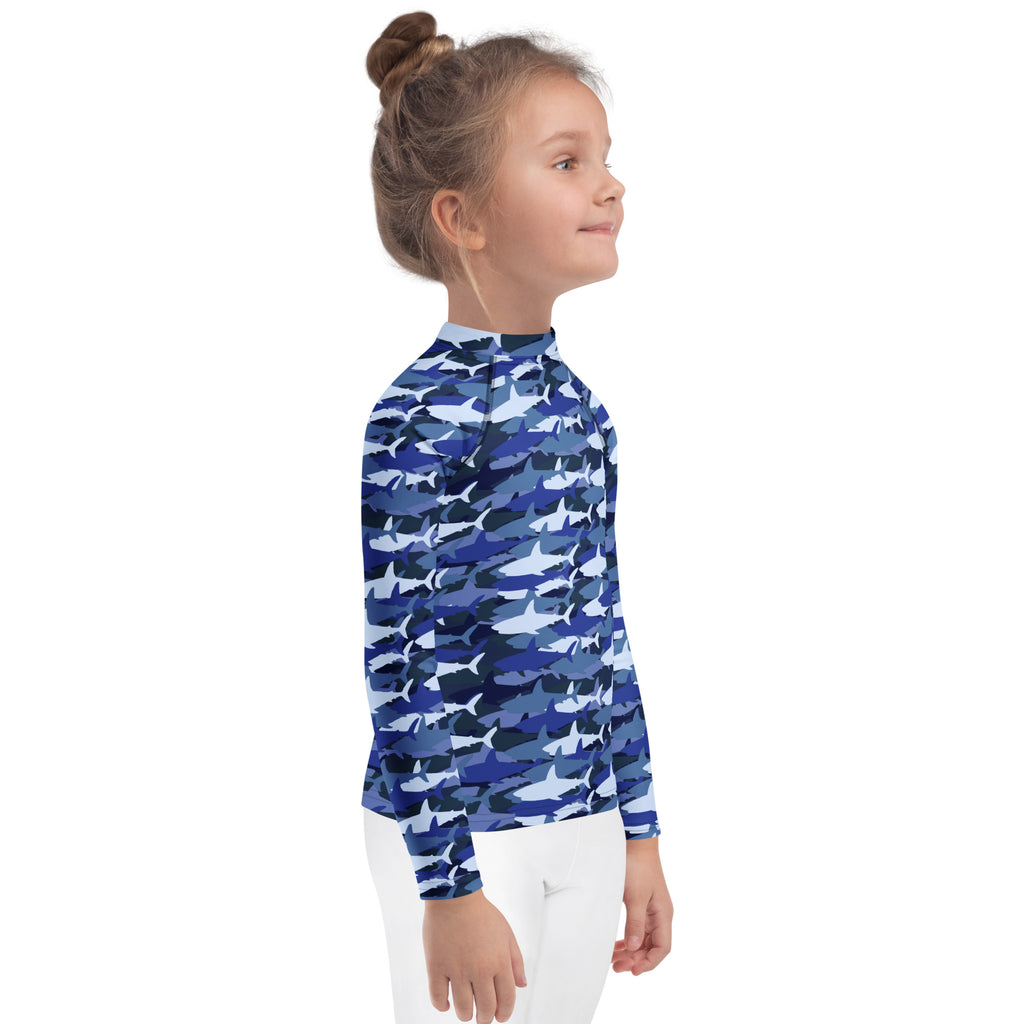 Kids blue shark long sleeve rash guard swim shirt with UPF 50 plus featuring a blue shark camouflage pattern