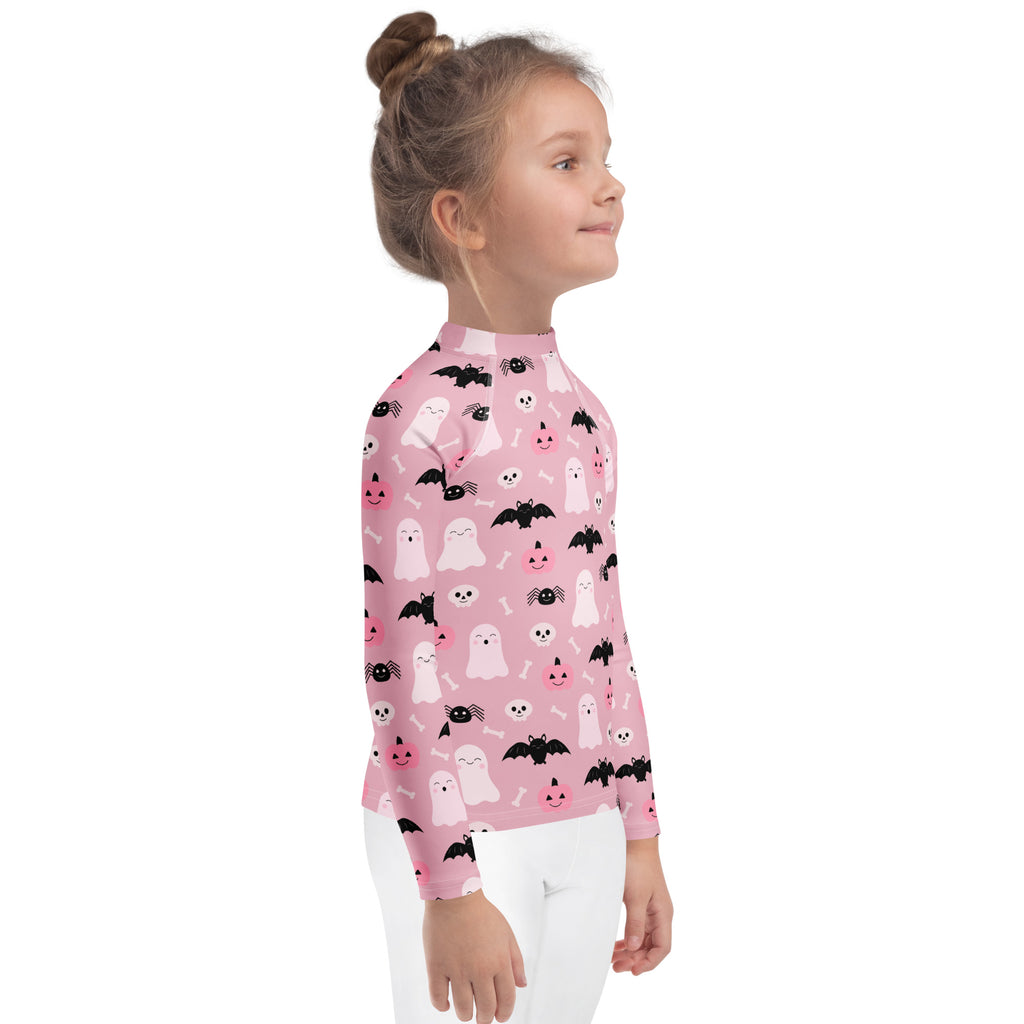 Girls pink long sleeve rash guard swim shirt with cute white ghosts black bats smiling skulls and UPF 50+ protection