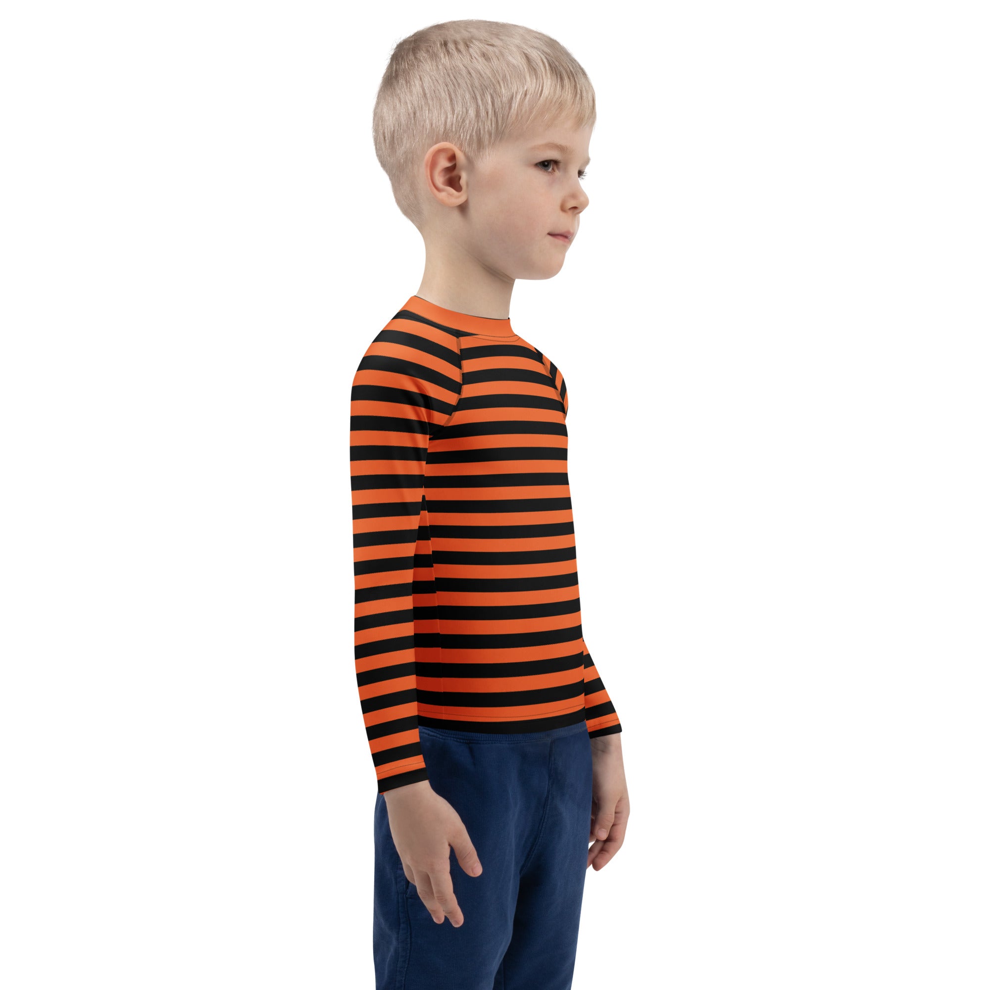 A child wearing a kids orange and black halloween long sleeve rash guard swim shirt with UPF 50+ protection