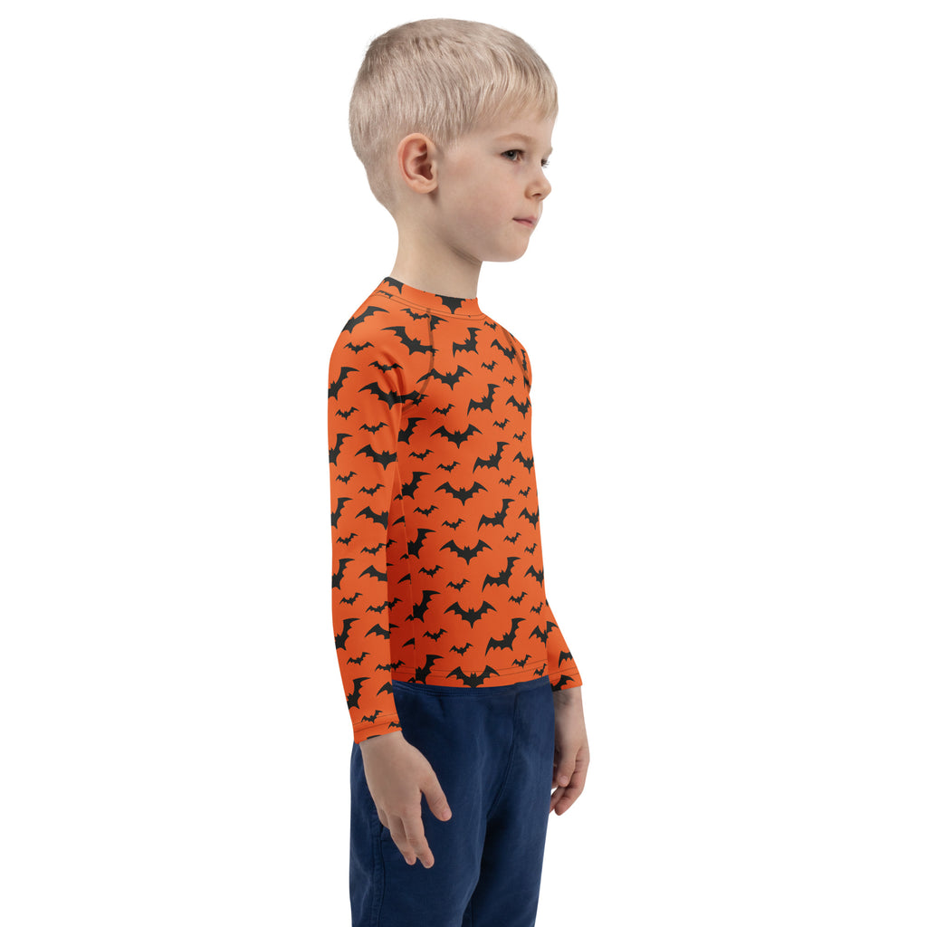 Kids orange long sleeve rash guard swim shirt with black bat pattern and UPF 50 plus for Halloween sun protection