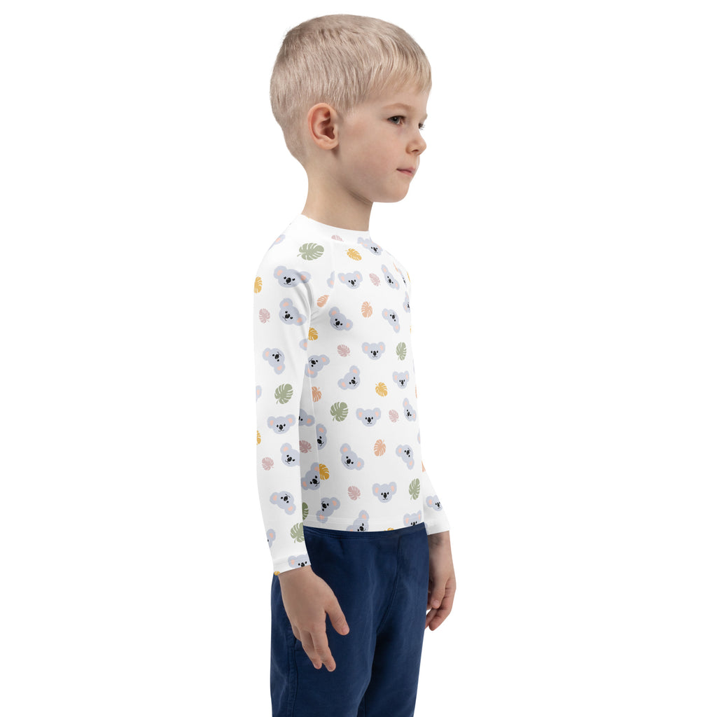 White long-sleeved kids koala bear rash guard swim shirt with playful gray koala and colorful leaf pattern upf 50+