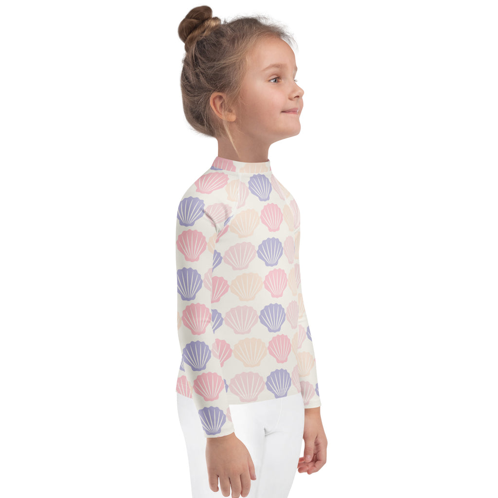 Kids seashell print long sleeve rash guard swim shirt with upf 50 plus in pastel pink and lavender on off white base