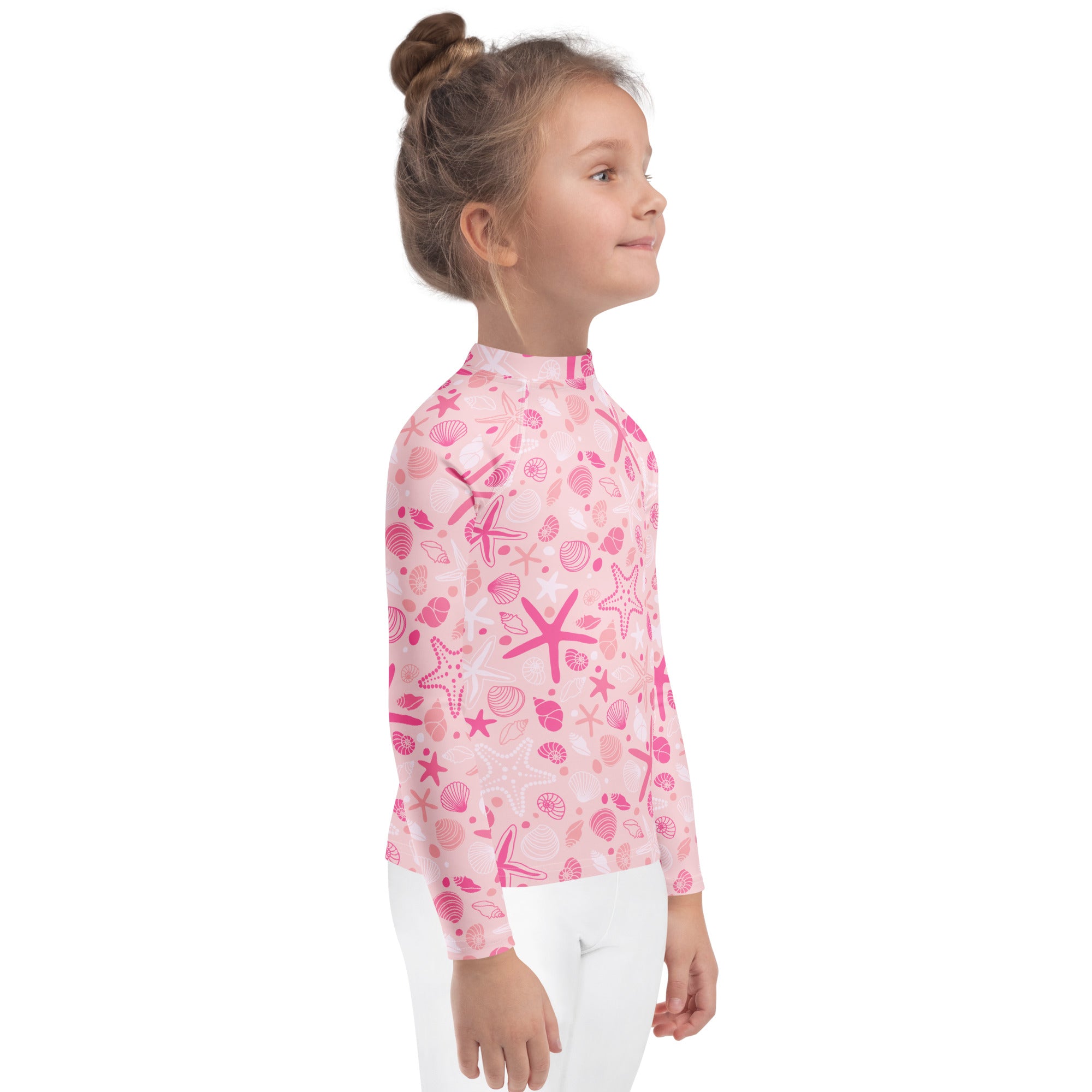 Girls pink long sleeve rash guard swim shirt with playful starfish and seashell pattern and UPF 50 plus protection