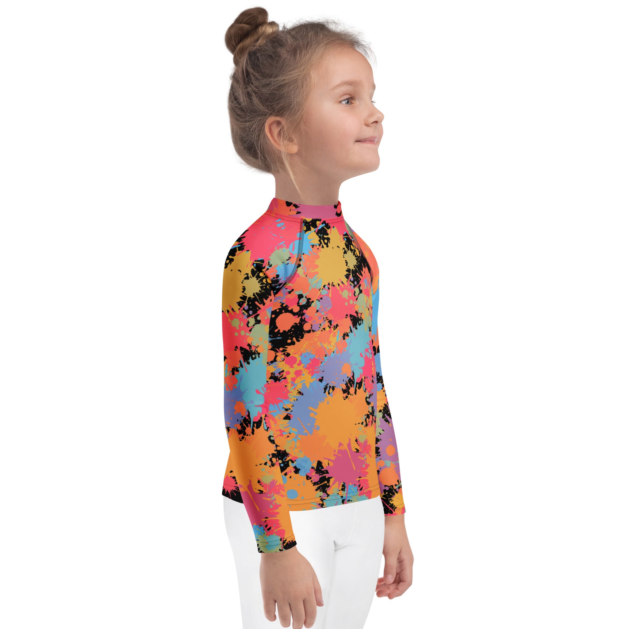 A kids long sleeve rash guard swim shirt with bold pink orange yellow blue and black paint splatter design and upf 50+