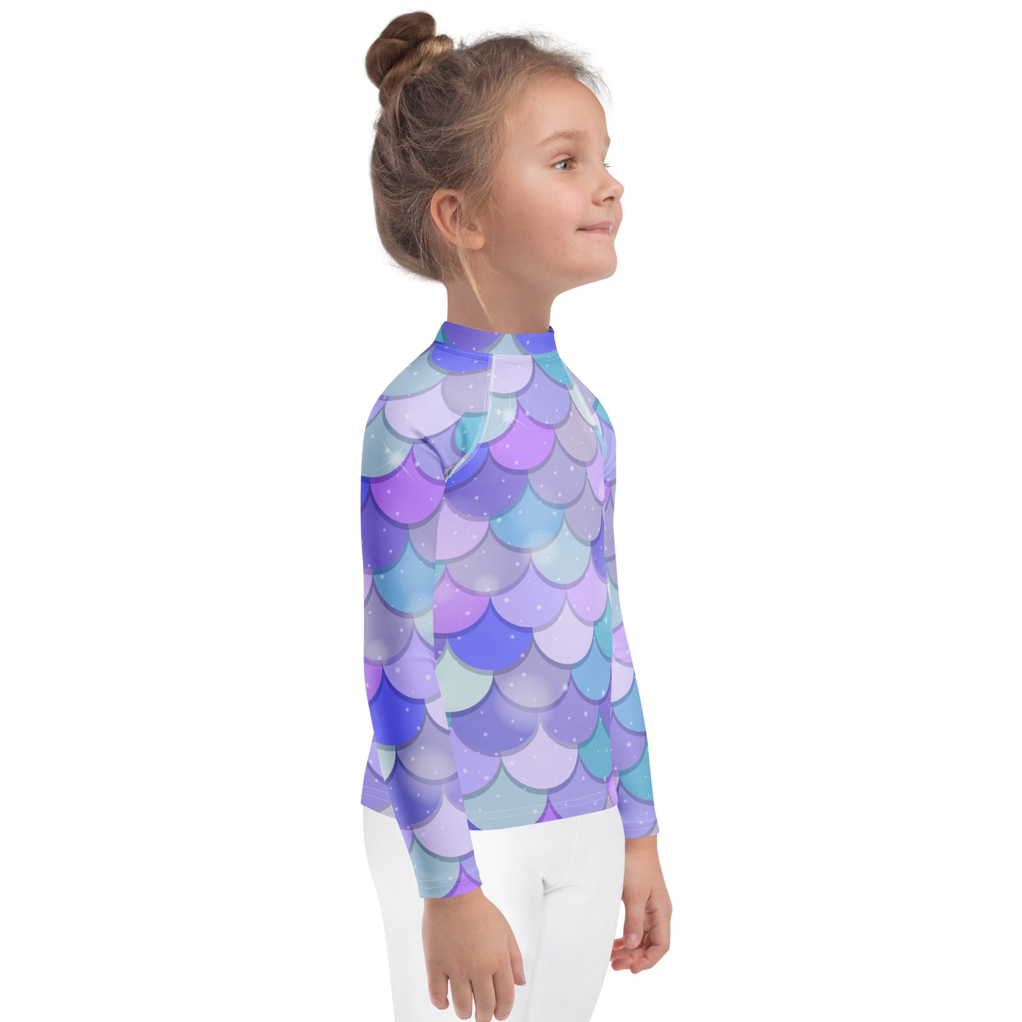 A child wearing a girls purple mermaid scales long sleeve rash guard swim shirt with UPF 50 plus protection