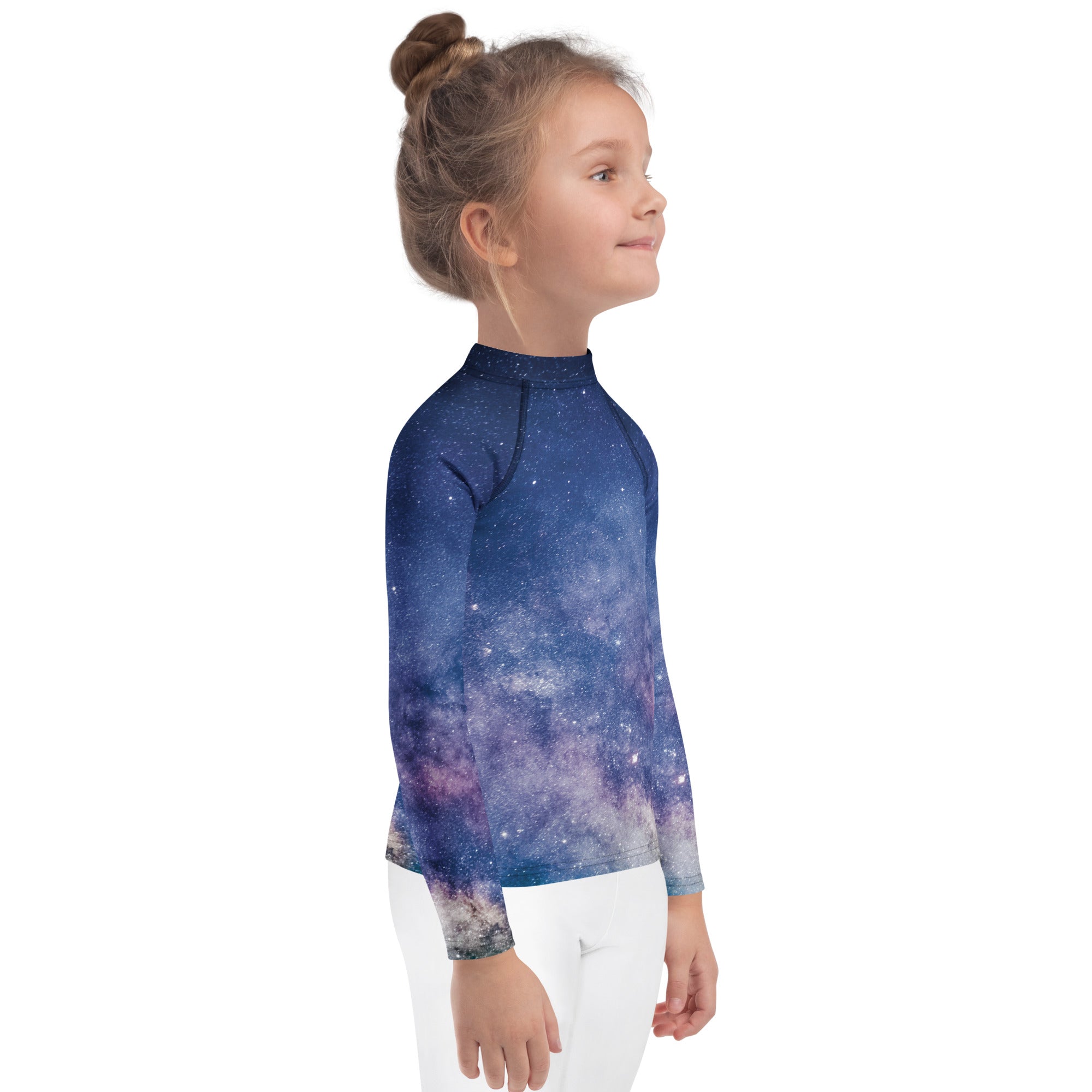 A child wearing a kids realistic galaxy long sleeve rash guard swim shirt in deep blue and purple with upf 50 plus protection