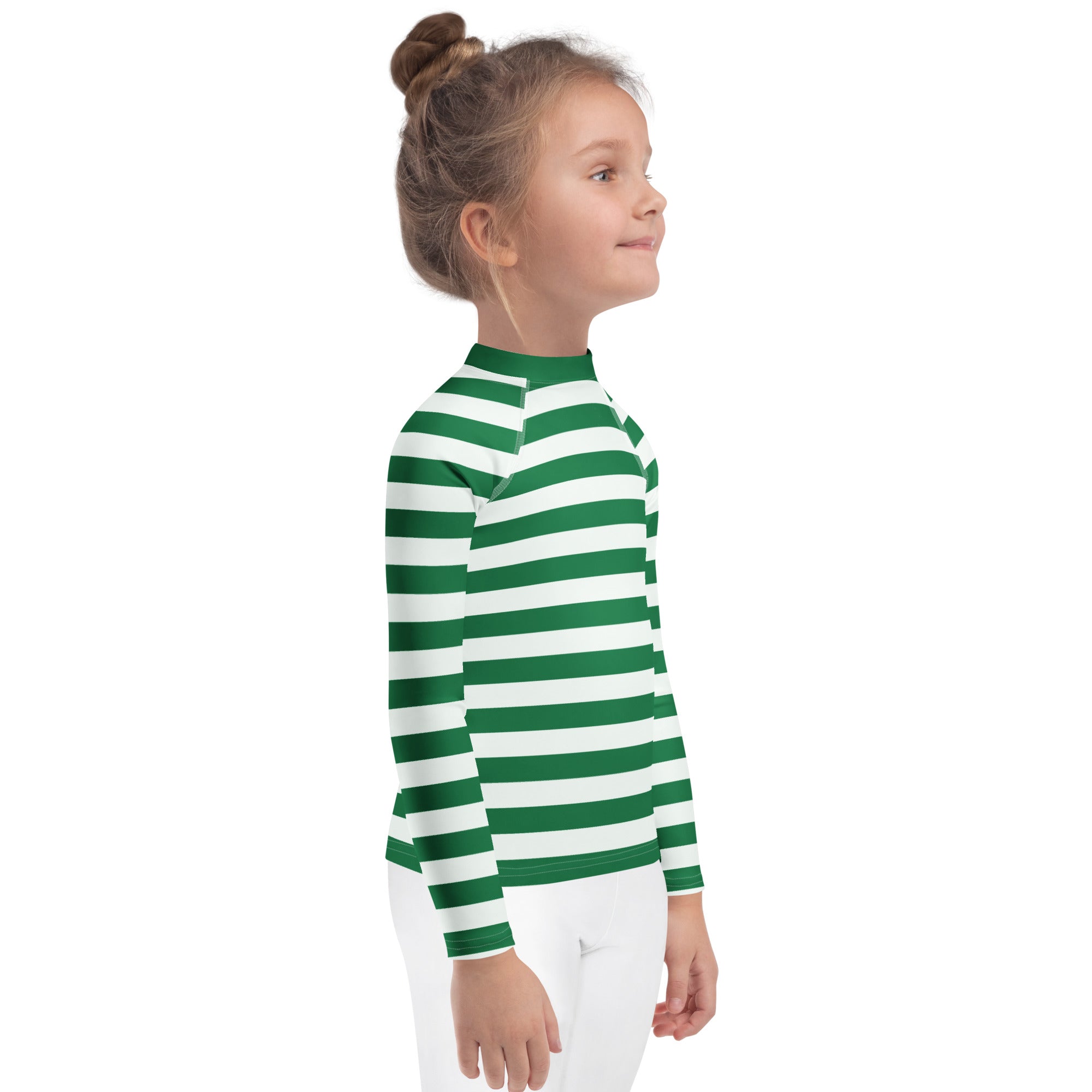 A child wearing a kids green and white striped christmas long sleeve rash guard swim shirt with UPF 50+ protection