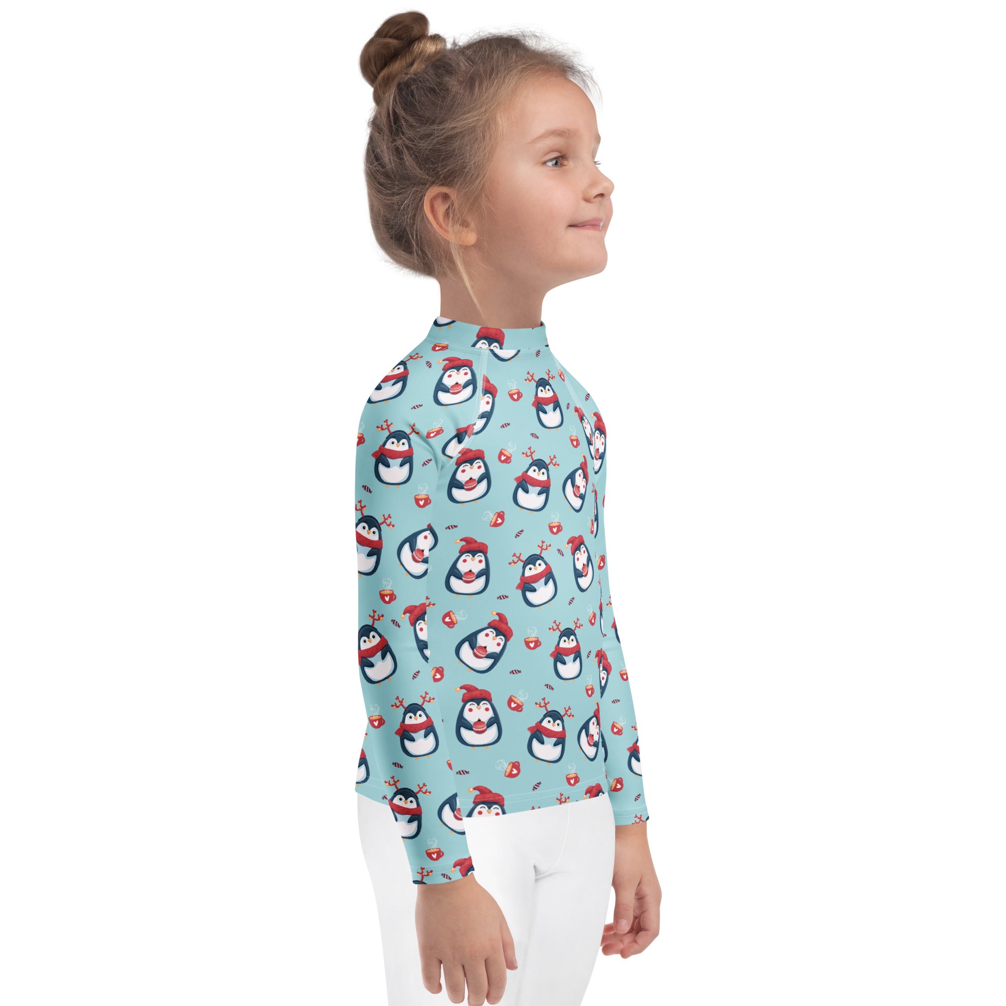 Kids reindeer penguin christmas long sleeve rash guard swim shirt in light blue with playful penguin pattern and upf 50+ protection
