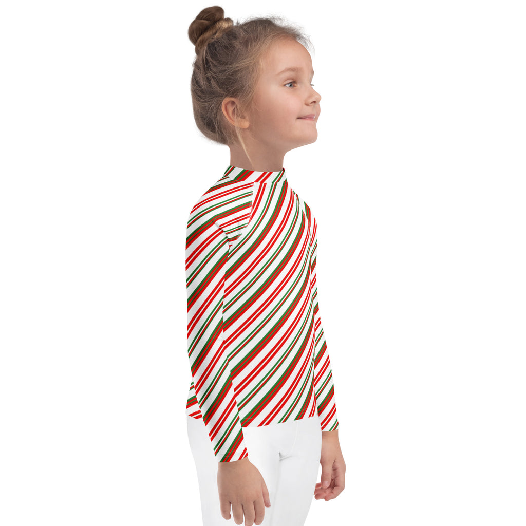 A child wearing a kids candy cane stripe Christmas long sleeve rash guard swim shirt with upf 50 plus