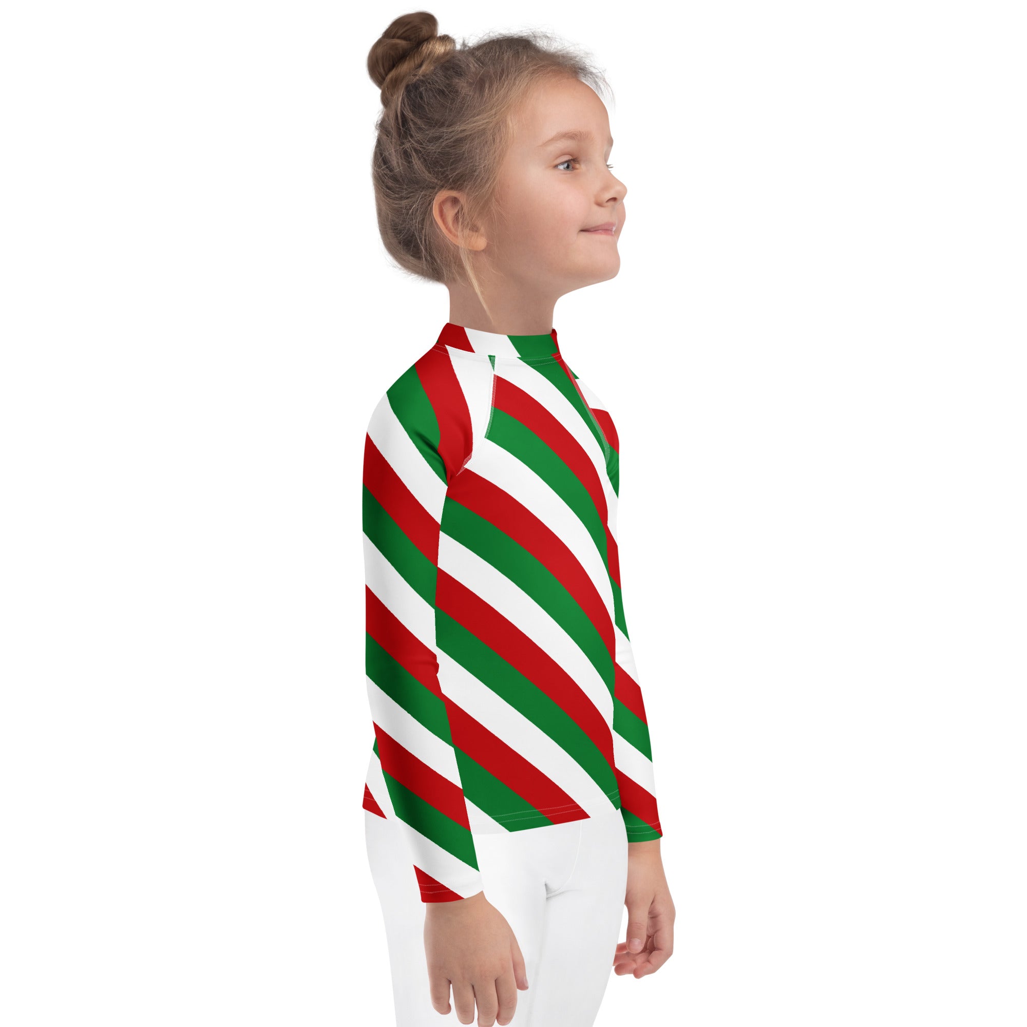 A child wearing a kids bold candy cane stripe christmas long sleeve rash guard swim shirt with upf 50 plus