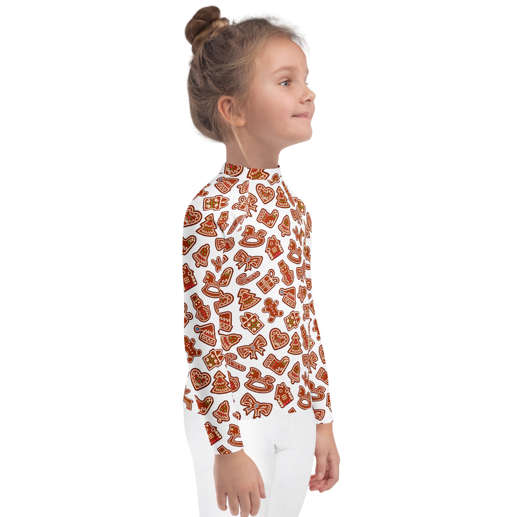 A child wearing a white long sleeve kids gingerbread cookie rash guard swim shirt with UPF 50 plus protection