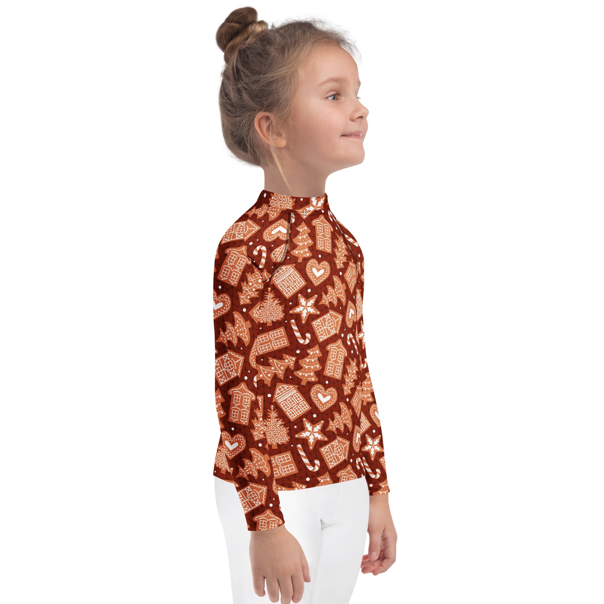 A child wearing a kids red gingerbread Christmas long sleeve rash guard swim shirt with UPF 50 plus and festive pattern