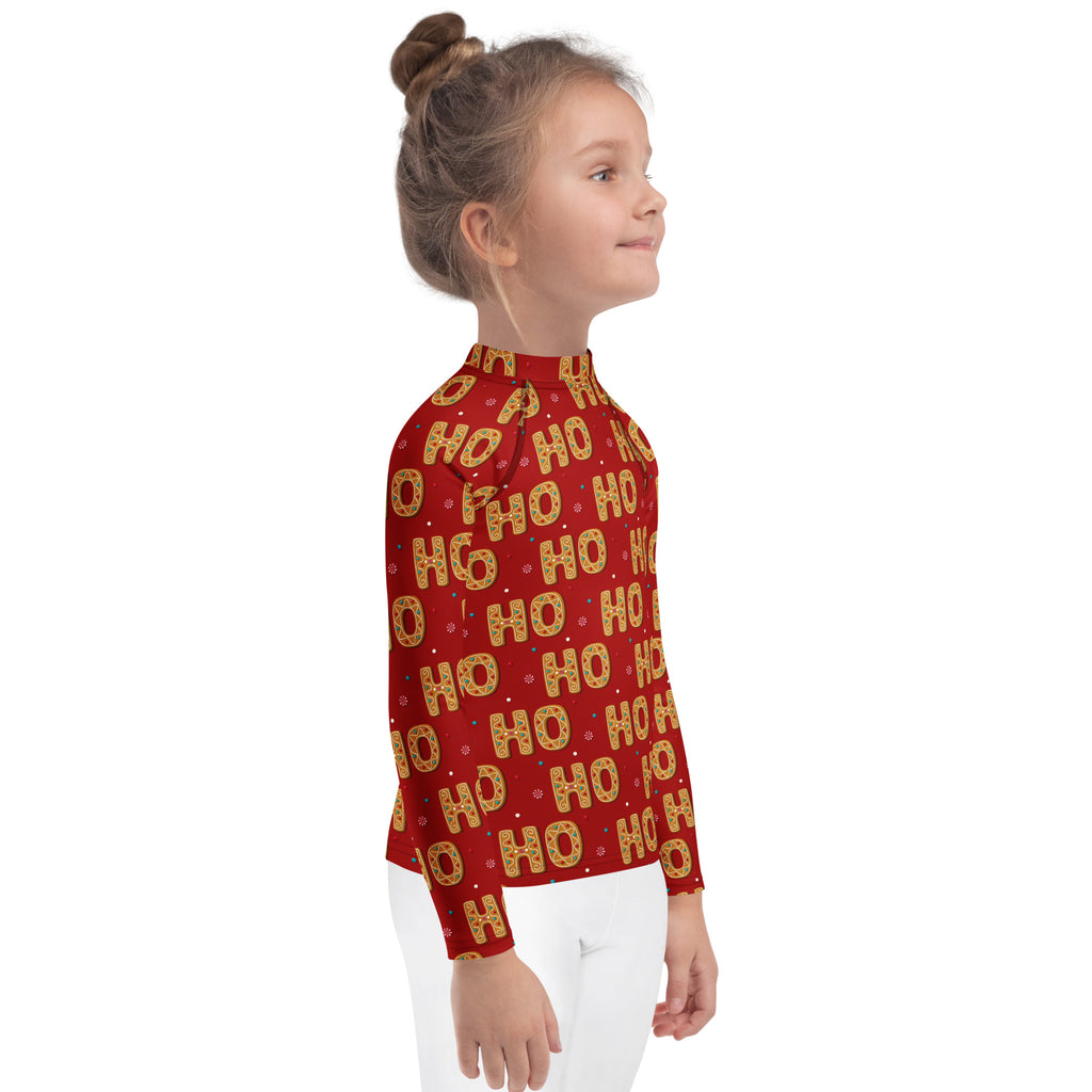 Kids ho ho ho gingerbread christmas long sleeve rash guard swim shirt in red with festive gold and white pattern and upf 50+