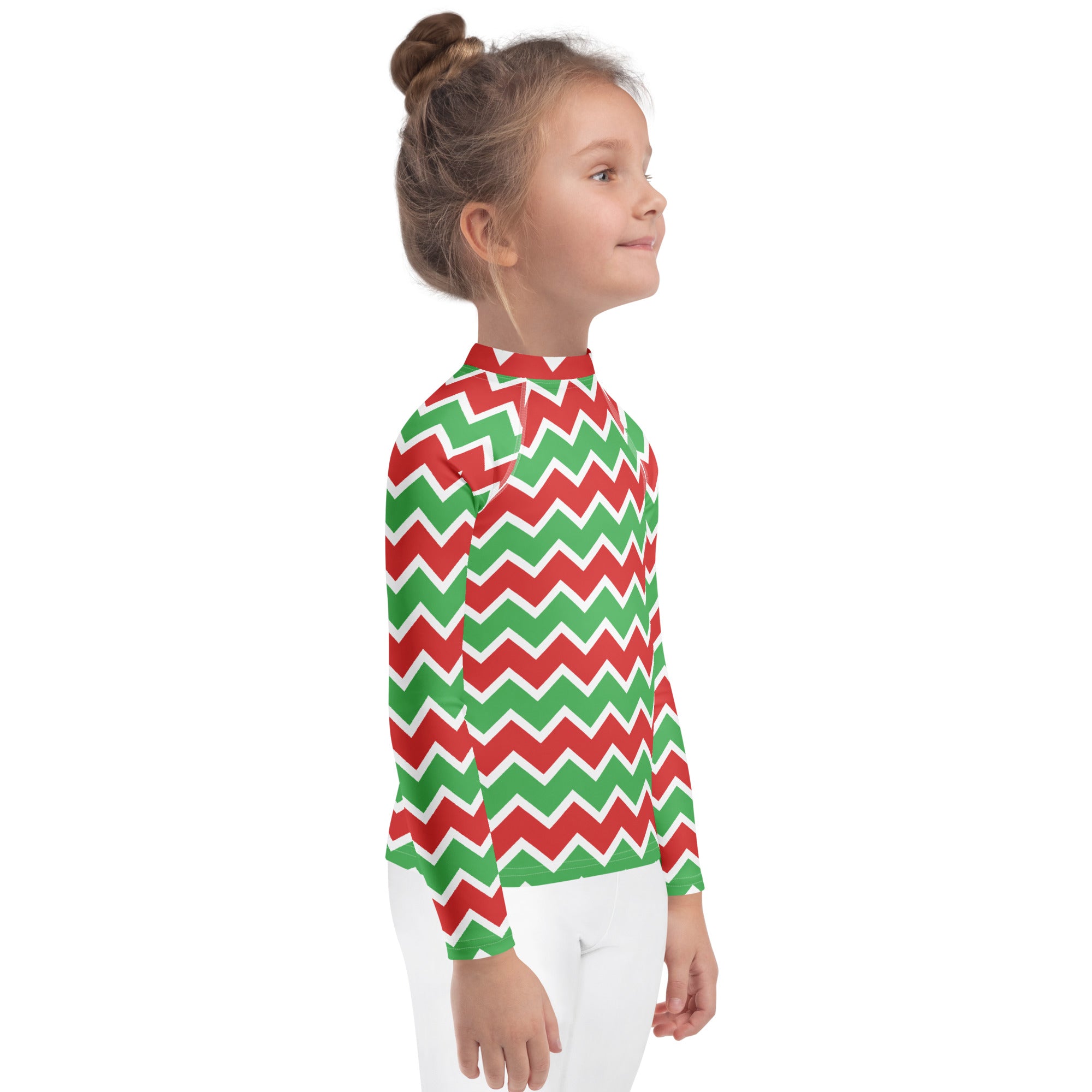 A child wearing a kids christmas chevron long sleeve rash guard swim shirt with red and green zigzag pattern and UPF 50+