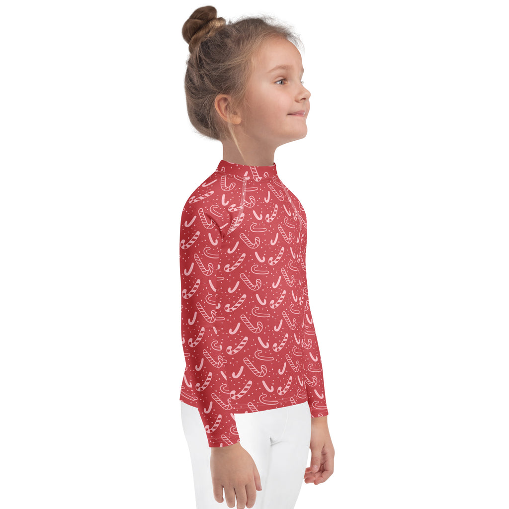 Kids red long sleeve rash guard swim shirt with white candy cane pattern and small dots with UPF 50 plus protection