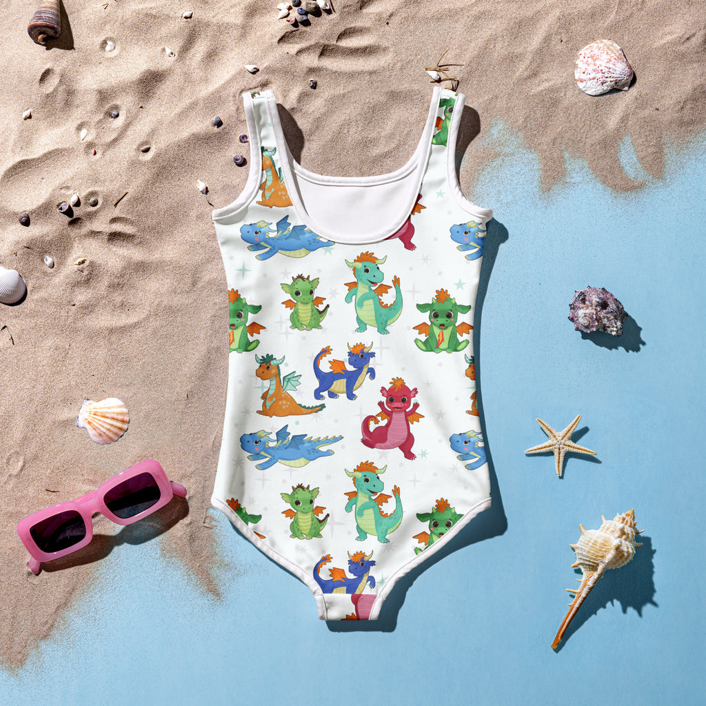 A white girls one-piece swimsuit with colorful cartoon dragons made from buttery soft fabric with UPF 50 plus protection