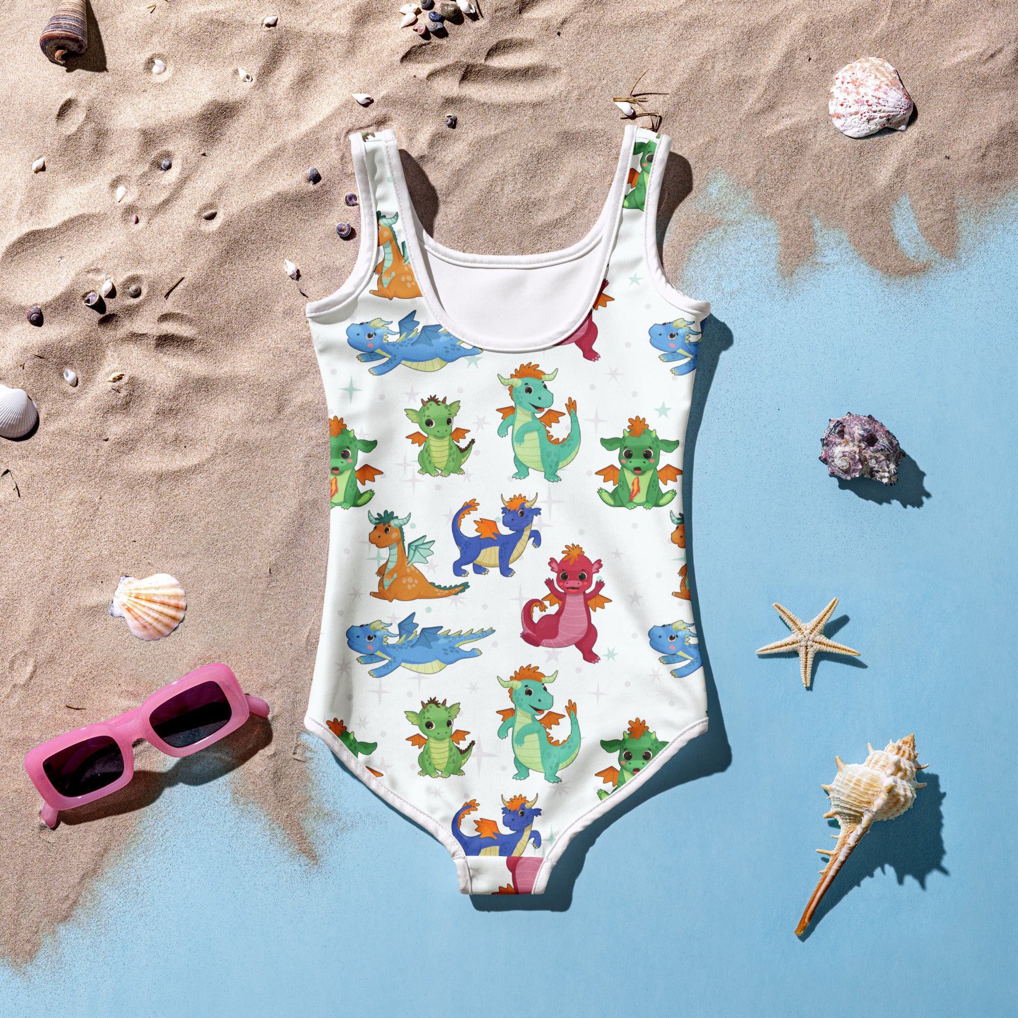 A white girls one-piece swimsuit with colorful cartoon dragons made from buttery soft fabric with UPF 50 plus protection