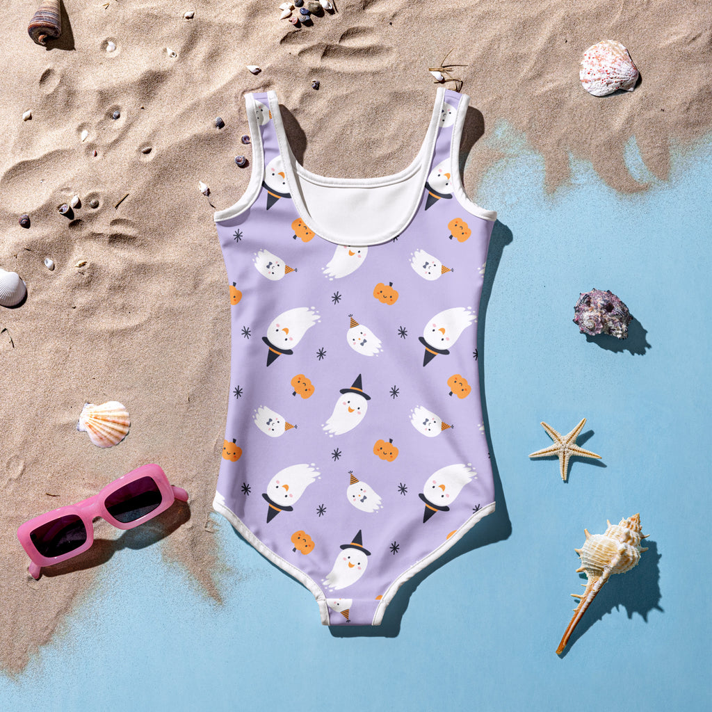 Girls ghost witch halloween swimsuit in lavender with white trim and playful ghost and pumpkin print in one piece design