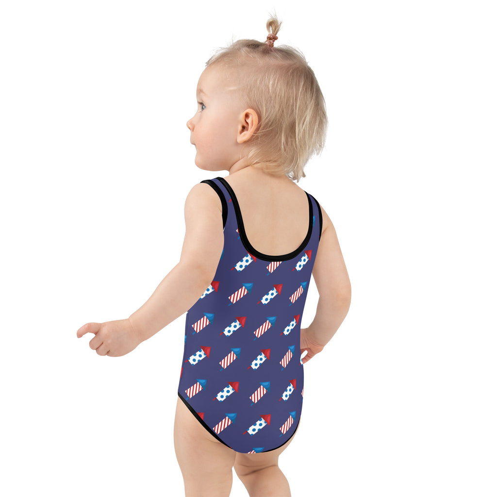 Girls firework rockets 4th of July buttery soft navy blue swimsuit with black trim and red white blue fireworks pattern