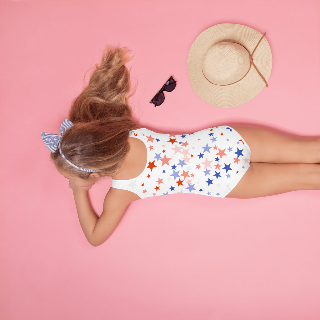 White girls one-piece swimsuit with red blue and pink star pattern perfect for 4th of July celebrations
