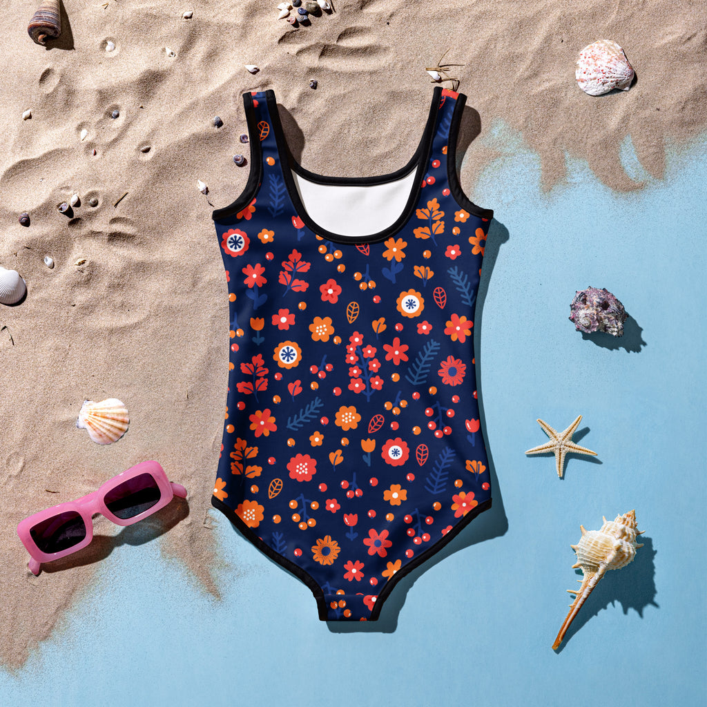 A navy blue girls one-piece swimsuit with vibrant orange red and white floral pattern and buttery soft fabric with upf 50+