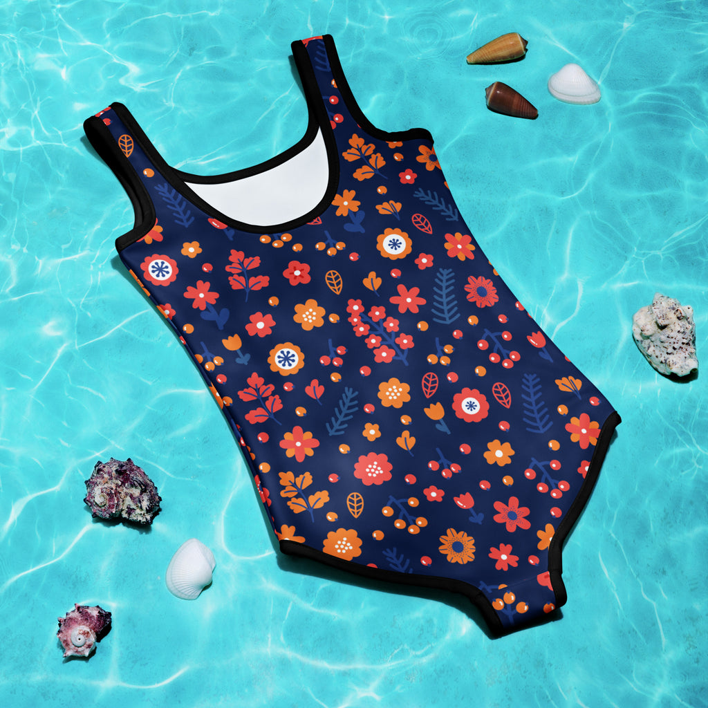 A navy blue girls one-piece swimsuit with vibrant orange red and white floral pattern and buttery soft fabric with UPF 50+