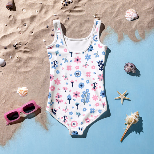 White one-piece girls swimsuit with playful pink and blue floral pattern buttery soft fabric and UPF 50 plus protection