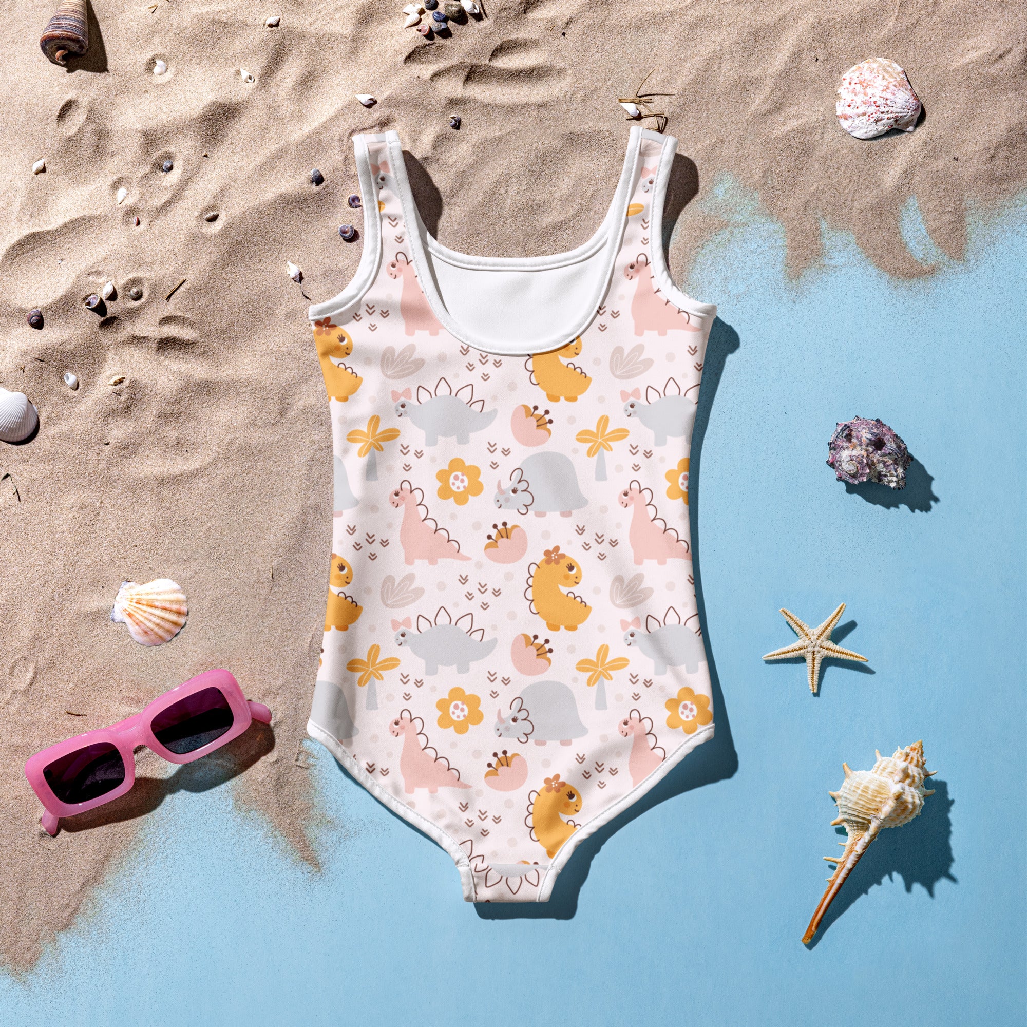 Girls floral dinosaur buttery soft swimsuit with upf 50 plus in pastel pink and yellow on a light cream base