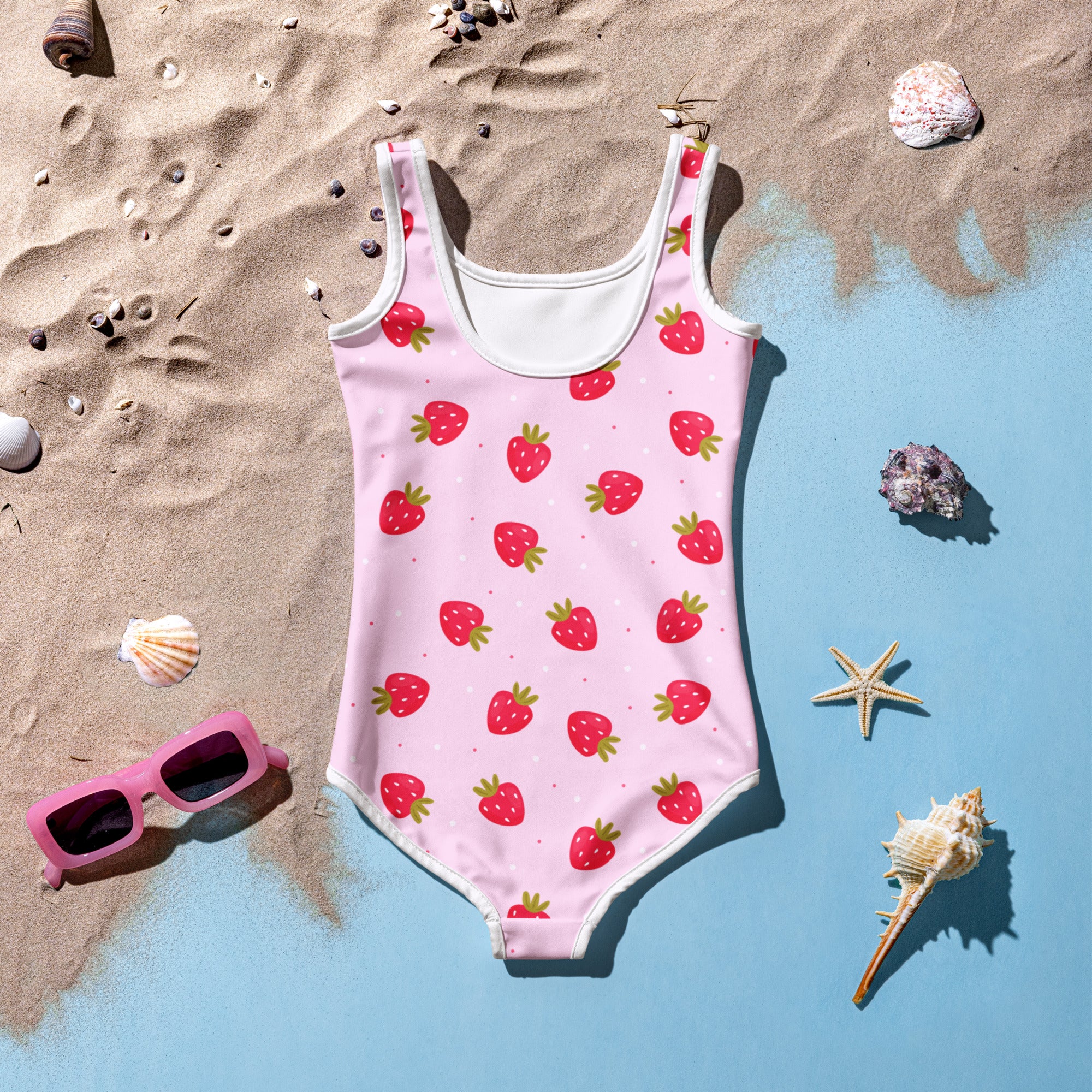 Pink strawberry-patterned girls buttery soft one-piece swimsuit with white trim and upf 50 plus protection