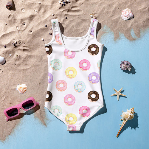 White girls one-piece swimsuit with pastel pink yellow purple and mint green donut pattern for birthday use
